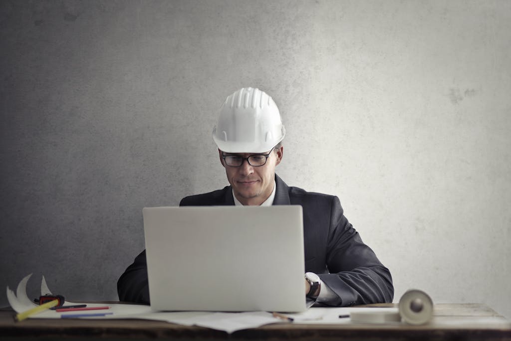 Engineer working with laptop at table